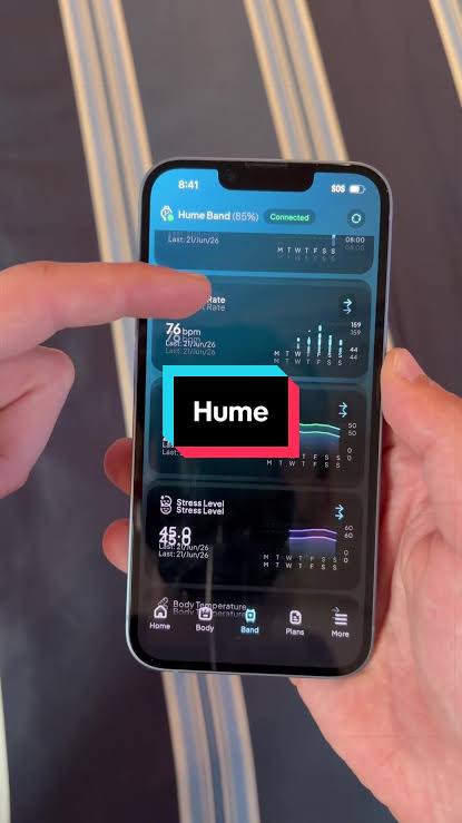 Person holding a smartphone showing the Hume Health app dashboard